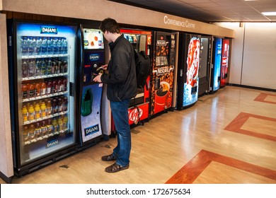 VANCOUVER, CANADA - MAY 12, 2007: Unidentified male student paying for the drinks from the vending machine at Simon Fraser University Convenience Centre.