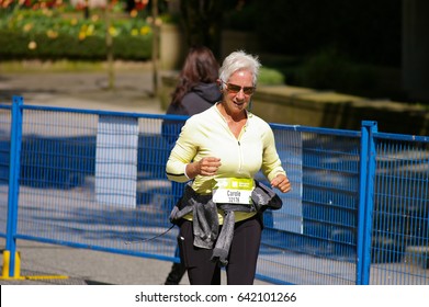 Vancouver, Canada - May 7, 2017: An Unidentified Older Woman Running In The BMO Vancouver Marathon Runs Up The Final Hill Towards The Finish Line.