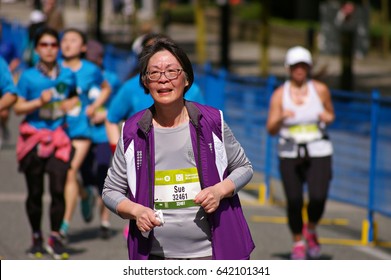 Vancouver, Canada - May 7, 2017: An Unidentified Older Woman Running In The BMO Vancouver Marathon Runs Up The Final Hill Towards The Finish Line.