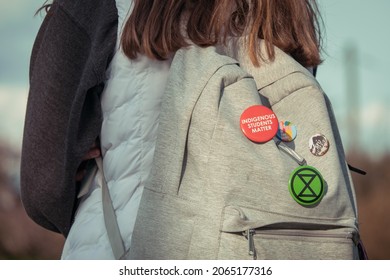 Vancouver, Canada - October 28, 2021: Woman standing with backpack with Canadian indigenous rights pins 