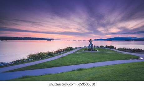 Vancouver Canada,May 2017. Inukshuk With Sunset Fluffy Clouds Backgrounds