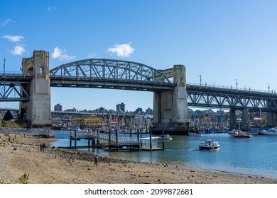 Vancouver City, BC, Canada - April 4 2021 : Aquatic Centre Ferry Dock, Sunset Beach Park, Burrard Street Bridge in the background.