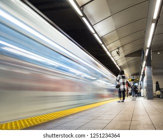 Vancouver City Center Station At Evening Rush Hour With Trains Rushing By And Commuters Waiting.