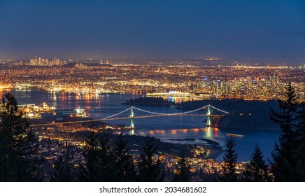 Vancouver City Downtown Panorama In Night. Vancouver Harbour Marina Aerial View. Lions Gate Bridge, British Columbia, Canada.