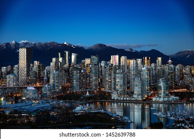 Vancouver Cityscape That Shows The Famous And Recently Built Vancouver House Framed With Snow-capped North Shore Mountains 