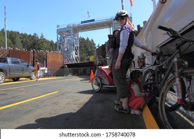 Vancouver Island, British Columbia Canada, June 3, 2020: BC Ferries Carry A Family With Vehicles As They Venture On A Cycling Trip Through The West Coast Gulf Islands.