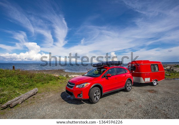 VANCOUVER ISLAND,\
BRITISH COLUMBIA, CANADA - May 10, 2018: Camping with antique tiny\
trailer, Vancouver\
Island