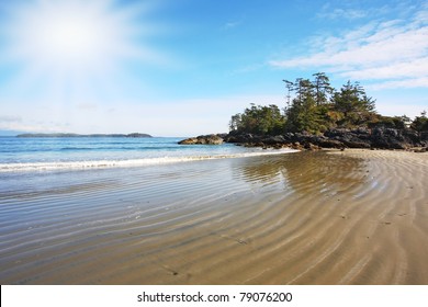 Vancouver Island. On The Pacific Beach Begins Tide, The Sand Lies Wet Waves