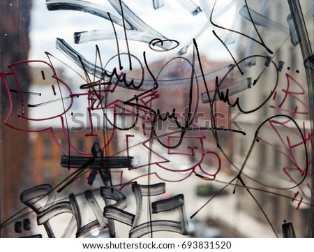 Vandal graffiti on the window of a house