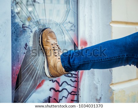 vandal man breaking the window and robbing the house