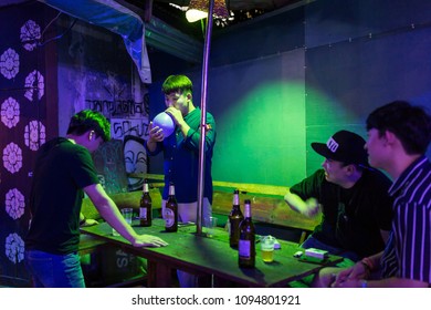 Vang Vieng, Laos - January 21, 2017: Unidentified Tourists Inhale The Laughing Gas Balloons In One Of The Bars In Vang Vieng, Laos