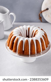 Vanilla bundt cake with sugar powder vanilla icing on a cake stand