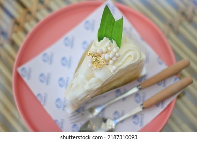 Vanilla Cake Mixed With Coconut, Decorated With Gold Leaf.