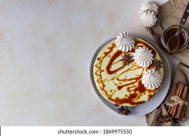 Vanilla Cheesecake With Carrot Cake Crust Served With Salty Caramel Topping And Meringue, Light Concrete Background. Selective Focus. Top View. Copy Space.