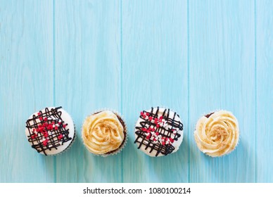 Vanilla and chocolate cupkcake with meringue on blue wood background. Top view. Copy space - Powered by Shutterstock