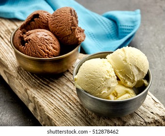 vanilla and chocolate ice cream on wooden board
