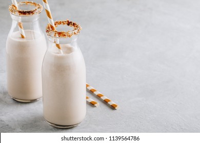 Vanilla cookie milkshake in glass bottles on a gray background - Powered by Shutterstock