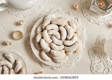 Vanilla crescents - homemade Christmas cookies on a white plate, top view - Powered by Shutterstock