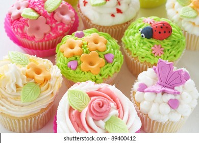 Vanilla cupcakes with buttercream icing and various decorations