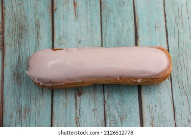 Vanilla Eclair On A Wooden Table