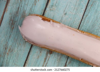 Vanilla Eclair On A Wooden Table