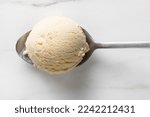 vanilla ice cream ball in a spoon, top view