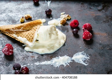 Vanilla Ice Cream In A Broken Waffle Cone On A Dark Metal Surface, Frozen Berries And Nuts. Copy Space, Top View.