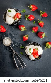 Vanilla Ice Cream In A Classic Ice-cream Bowls With Strawberries And Mint, Ice Cream Spoon On Dark Gray Stone Table, Top View 