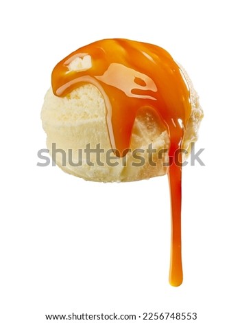 vanilla ice cream with melted caramel sauce isolated on white background
