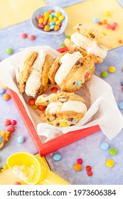 Vanilla ice cream sandwich with chocolate chip cookies and colorful chocolate lentils