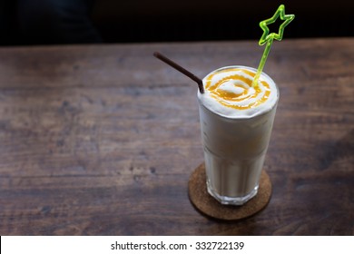 Vanilla Milk Shake On Wooden Table.