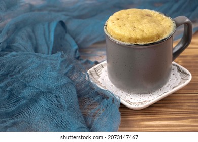 vanilla mugcake is microwaved. Homemade cupcake in a coffee mug. Mini cupcake in a mug. biscuit cake for one. Easy cooking concept, microwave baking. muffin vanilla. Vanilla dessert. food background