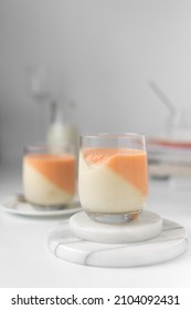 Vanilla and orange creamsicle panna cotta, panna cotta served in a glass cup, cooked cream in a glass cup, coral panna cotta dessert