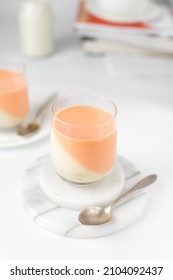 Vanilla and orange creamsicle panna cotta, panna cotta served in a glass cup, cooked cream in a glass cup, coral panna cotta dessert