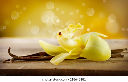 Vanilla. Pods And Flower Of Vanilla Over Wooden Background. Vanilla Pod Stick 