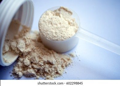 Vanilla Protein Powder In Scoop On White Background