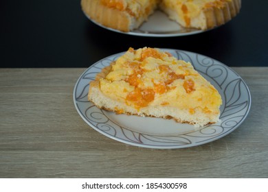 Vanilla pudding cake with tangerines. Plates on a wooden table.