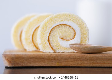 Vanilla roll cake on wood tray