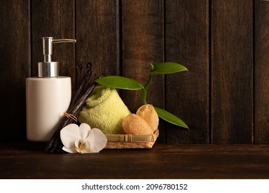 Vanilla Scented Liquid Soap, Towel And Loofah On And Old Wood Background.