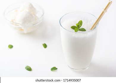 Vanilla Shake With Ice Cream And Mint On White Background. Vanilla Ice Cream Milk Shake. Banana Smoothie With Mint And Vanilla.