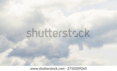 Vanilla sky clouds background in Cloud Dancer color trend. Minimal blue sky backdrop with calm atmosphere