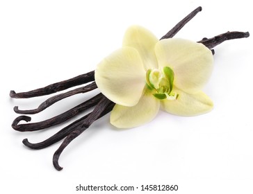 Vanilla Sticks With A Flower On A White Background.