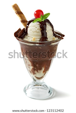 Vanilla sundae ice cream with sauce, syrup or sherbet and wafer stick, sweet cherry, mint and chocolate curls in sundae glass isolated on white background 