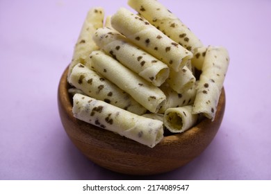 Vanilla sweet Wafer Cream Rolls isolated on violet background - Shutterstock ID 2174089547