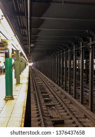 vanishing point of perspective looking down subway tracks in new york city