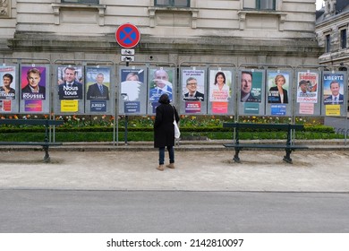 Vannes, France, April 5, 2022 : Woman from behind in front of the panels of the various candidates for the French presidential election