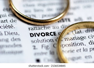 Vannes, France, July 29, 2008: French divorce concept with two wedding rings surrounding the word divorce