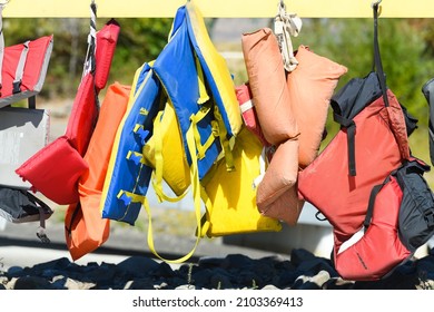 Vantage, WA, USA - September 20, 2021; Multi colored life vests with brand names hanging from hooks and available for loan as floatation devices