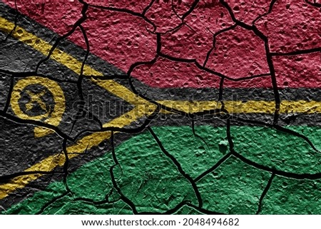 Vanuatu flag on a mud texture of dry crack on the ground