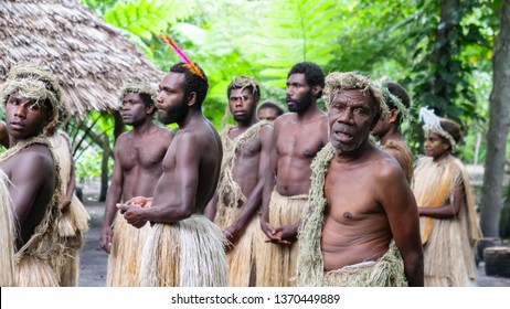 VANUATU ISLANDS, DECEMBER 2018: CLOSE UP: Indigenous Tribe In Vanuatu Performing A Ceremony In A Tropical Forest. Cheerful Group Of Locals In Traditional Outfits Celebrating By Singing And Dancing.